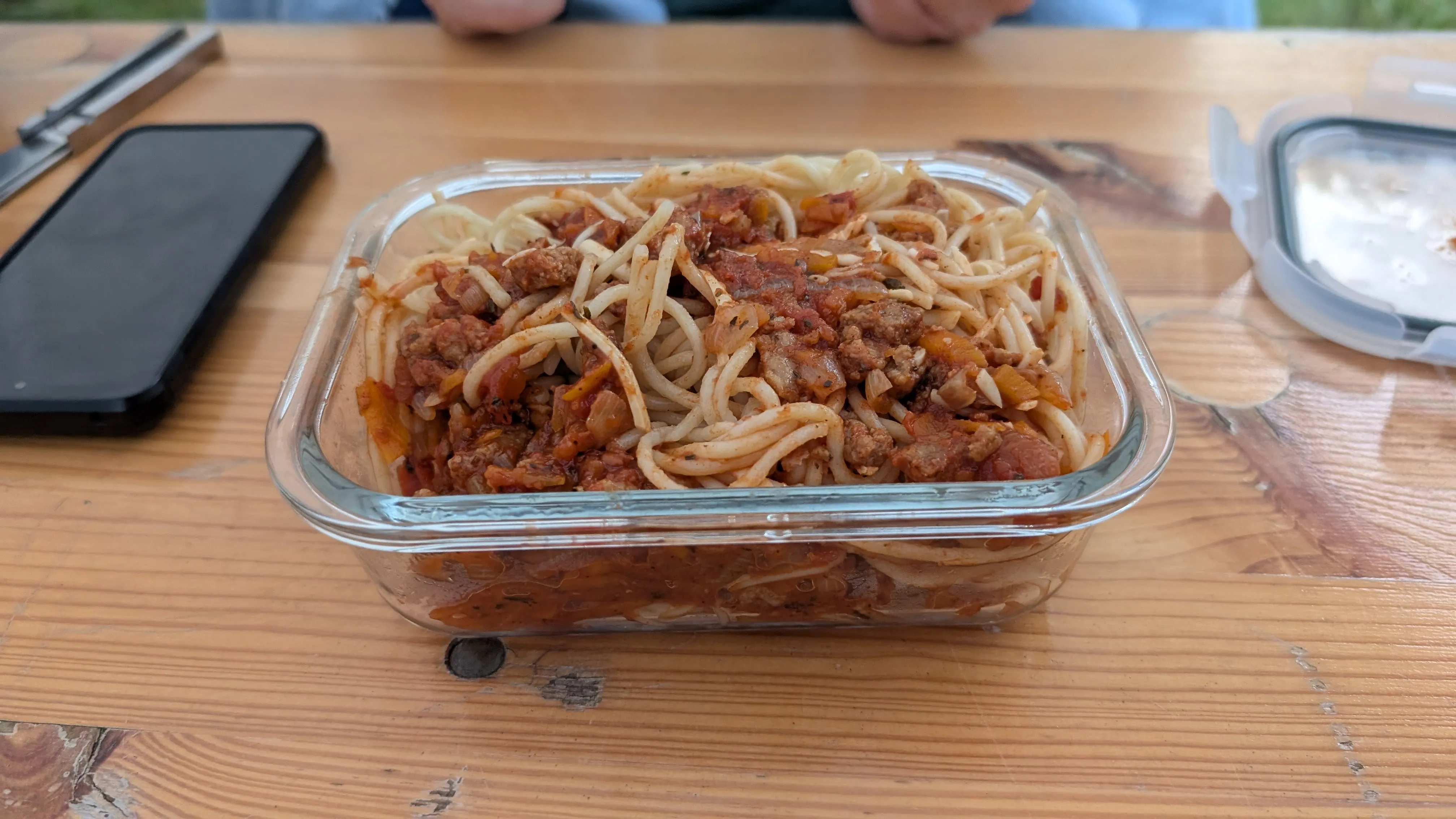 Leftovers from a meal in a food container on a table.