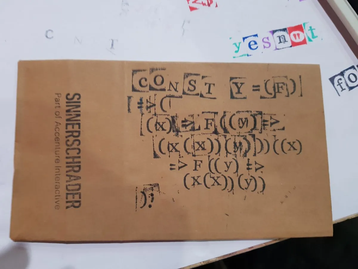 Picture of JavaScript code for a y-combinator stamped onto a brown paper bag